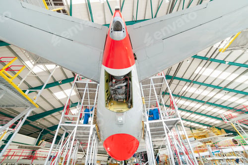 Preview: Low-Angle Shot Of Engineers On Scaffolding Assembling A Passenger Jet At A Hangar.
