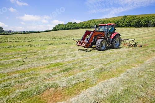 Preview: Side View Of A Tractor Turning Cut Grass To Dry For Hay