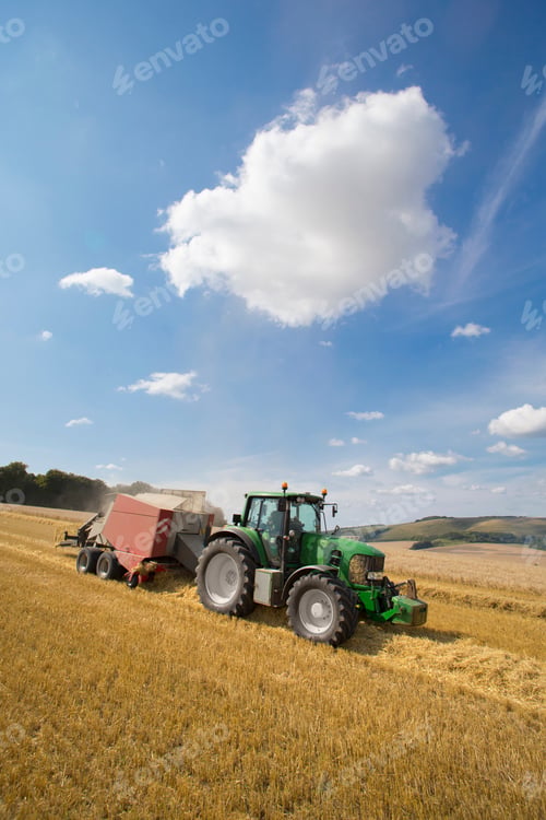 Preview: Vertical Shot Of A Tractor Stacking Straw Using A Baling Machine In A Rural Field.