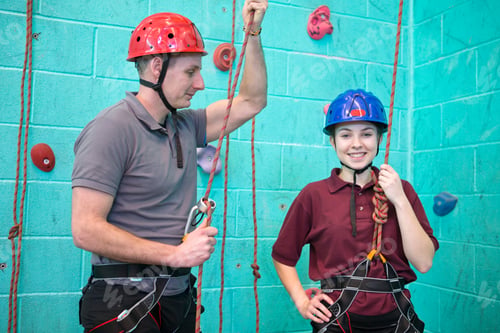 Preview: Portrait Shot Of A High School Student In Harness Standing With A Gym Teacher Against A Rock