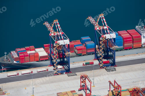 Preview: Aerial View Of Container Ship Moored At A Commercial Dock Being Unloaded Using Gantry Cranes