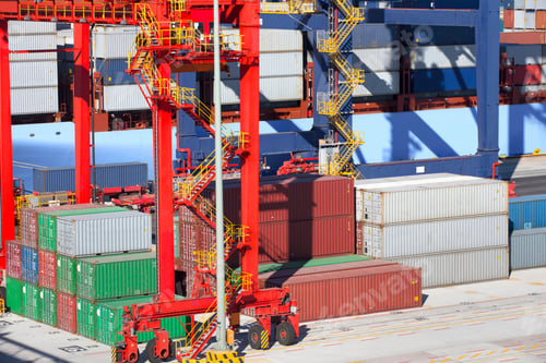 Preview: Cranes And Stacked Cargo Containers At A Commercial Dock.