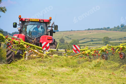 Preview: Tractor Turning Cut Grass To Dry For Hay