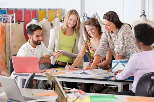 Preview: A Designer Reading From A Book And Teaching A Group Of Young Students In A Classroom.