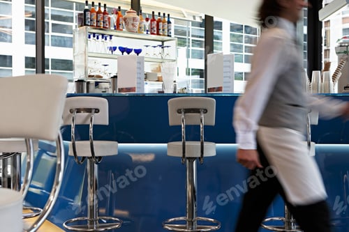 Preview: Motion Blur Of A Waiter Walking Across In A Bar.