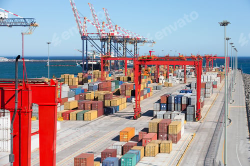 Preview: Extreme Wide Shot Of Cranes And Cargo Containers At A Commercial Dock With The Sea And Sky In The