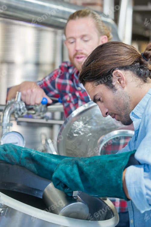 Preview: Brewery Workers Checking Fermentation Process In Steel Vat