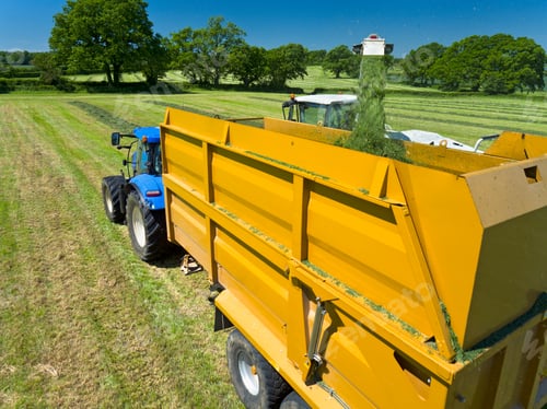 Preview: Forage Harvester Cutting Grass Silage Crop And Filling Tractor Trailer