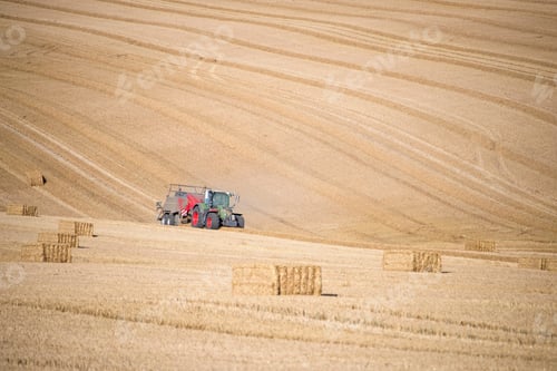 Preview: Tractor Baler Making Straw Bales In Field After Summer Wheat Harvest On Farm