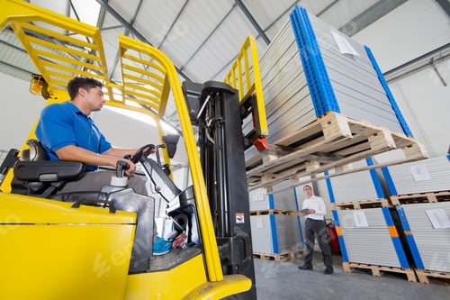 Preview: Businessman Supervising Forklift Truck Driver Worker In Solar Panel Factory Warehouse