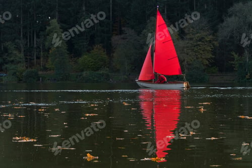 Preview: Man Sailing Dinghy With Red Sail On Autumn Lake