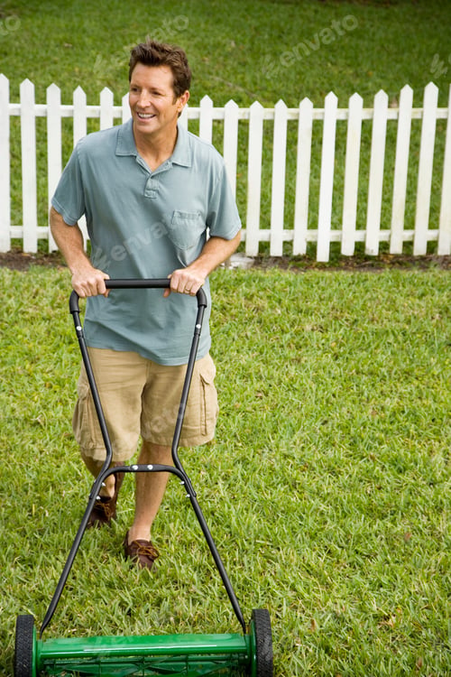 Preview: Man Mowing The Lawn On A Warm Day