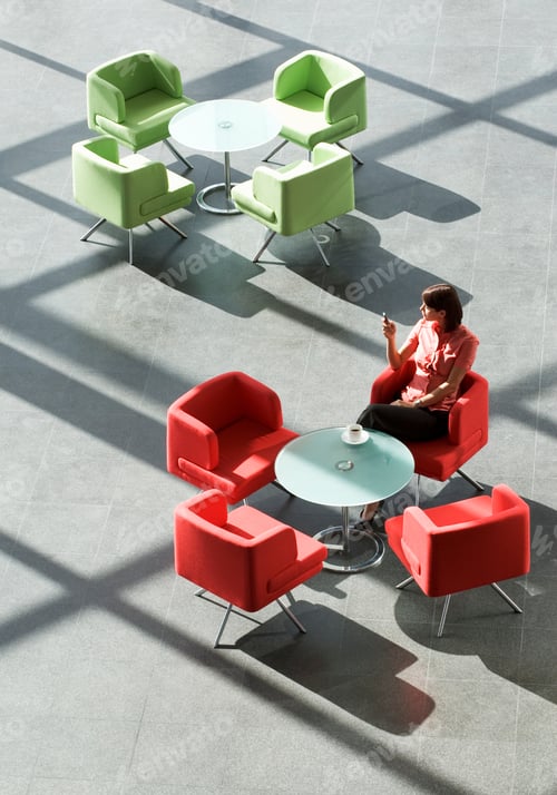 Preview: A Businesswoman Sitting At A Table Looking At A Mobile Phone