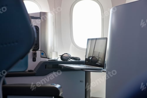 Preview: Laptop Computer On Table In Business Class Cabin Of Passenger Jet