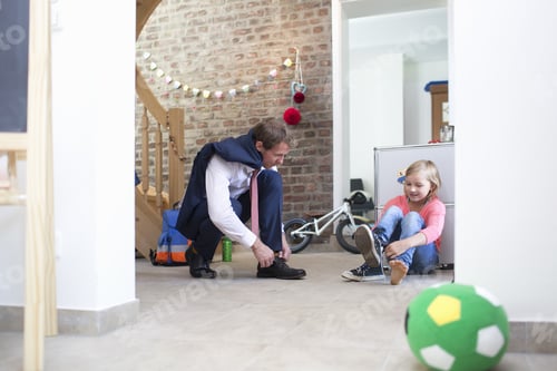 Preview: Father Tying Shoe Laces for Young Girl