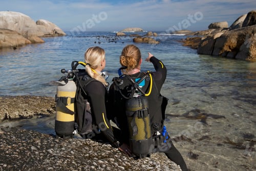 Preview: Couple In Wetsuits Going Ocean Scuba Diving From Rocky Beach