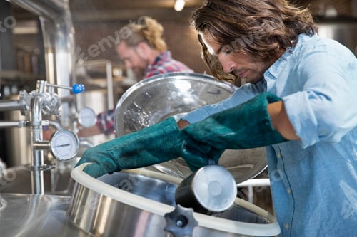 Preview: Brewery Workers Checking Fermentation Process In Steel Vat