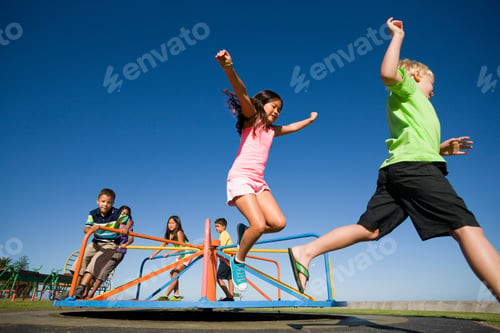 Preview: Children Jumping Off A Merry-Go-Round At A Playground