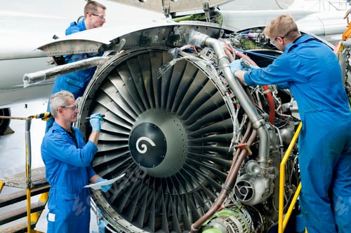 Preview: Medium Shot Of Engineers Repairing The Turbine Engine Of A Passenger Jet At A Hangar.