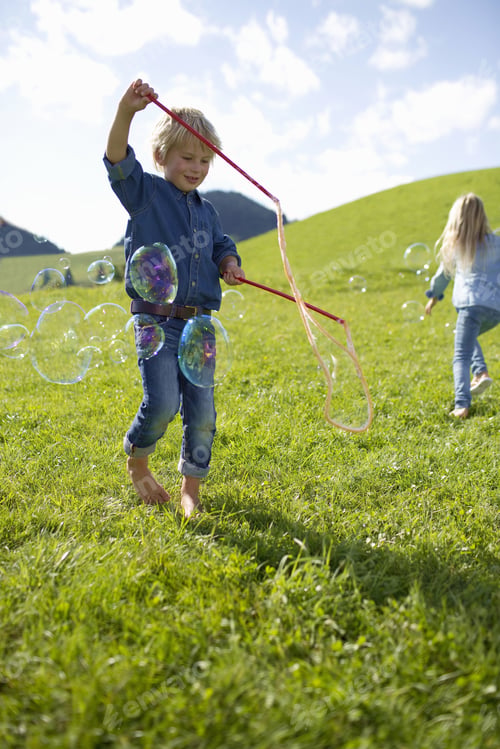 Preview: Children Making Giant Bubbles In Countryside