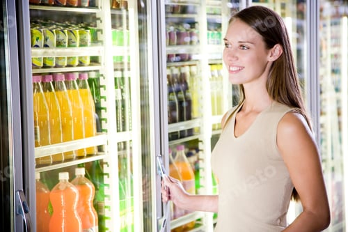 Preview: Woman Opening A Refrigerator Door In A Supermarket