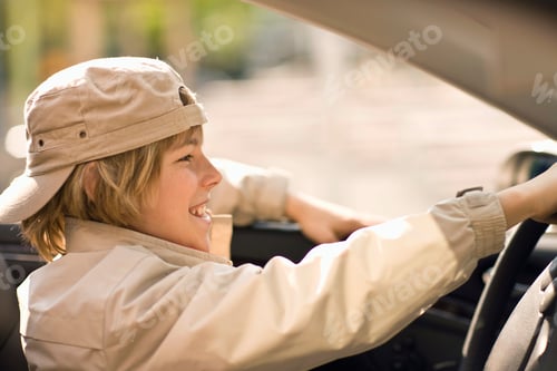 Preview: Happy Pre-Adolescent Boy Sitting In Convertible, Munich, Germany
