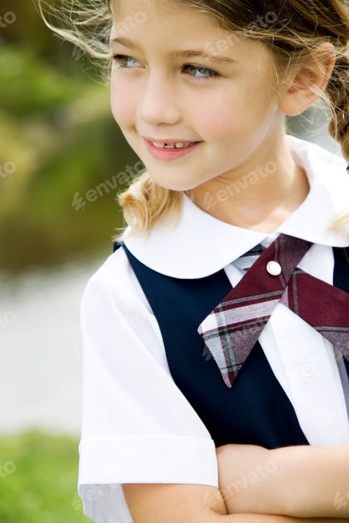 Preview: Smiling Girl in School Uniform Outside on Sunny Day