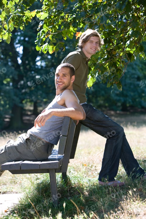 Preview: Two Young Men Sitting On A Bench, Smiling