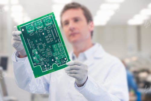 Preview: Close-Up Shot Of Engineer Holding A Printed Circuit Board In A Manufacturing Plant.