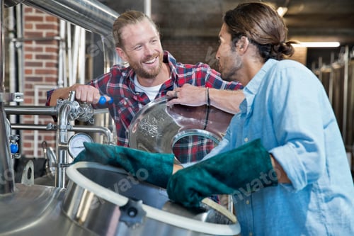 Preview: Brewery Workers Checking Fermentation Process In Steel Vat And Talking To Each Other