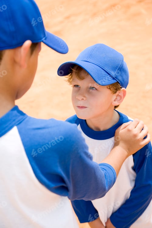 Preview: Older Boy Talking Down To Younger Boy At Baseball Practice