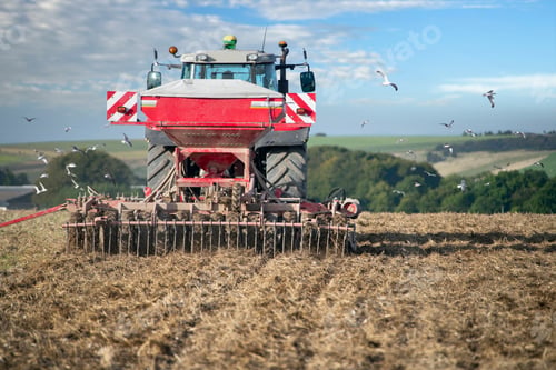 Preview: Rear View Of Tractor Pulling Drill Sowing Wheat Seed