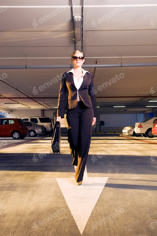 Preview: A Businesswoman Walking In A Car Park