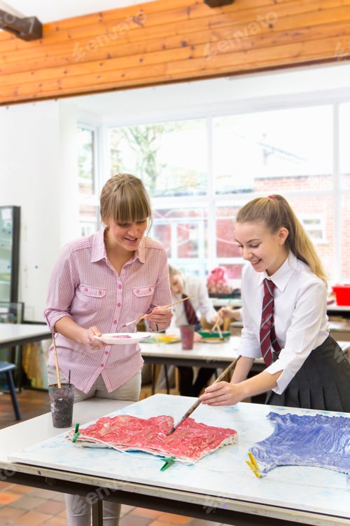 Preview: Vertical Shot Of An Art Teacher Guiding A Middle School Student During An Art Class.