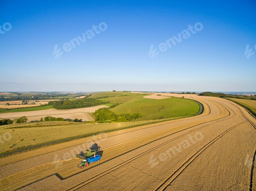 Preview: Scenic Aerial Landscape View Of A Combine Harvester Filling Tractor Trailer In A Sunny Barley Field