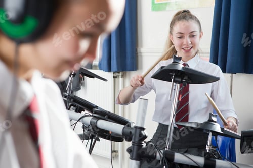 Preview: Female High School Student Playing Drums During A Music Class.