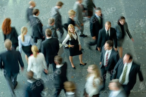 Preview: Confident Woman in Business Setting Among Moving People