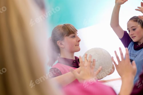 Preview: Side View Of A High School Student Playing Volleyball During A Gym Class.