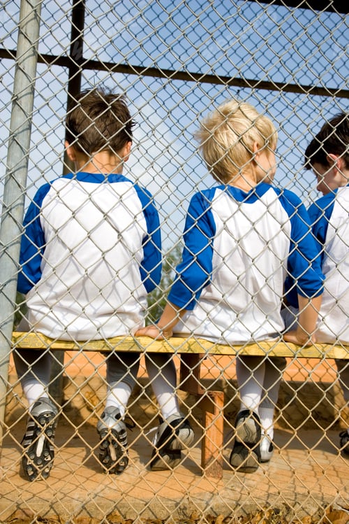 Preview: Rear View Of Baseball Team Sitting On Bench