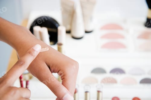Preview: Woman Testing Foundation Cream On Her Hand At The Cosmetics Counter