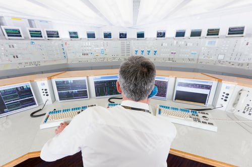 Preview: Backside Of A Senior Engineer Speaking On The Telephone At The Control Desk In The Control Room Of