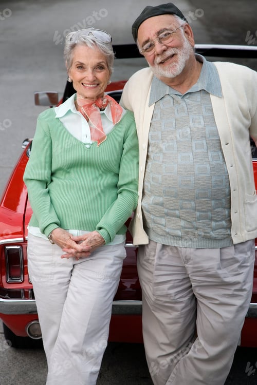 Preview: A Senior Couple Standing By A Sports Car