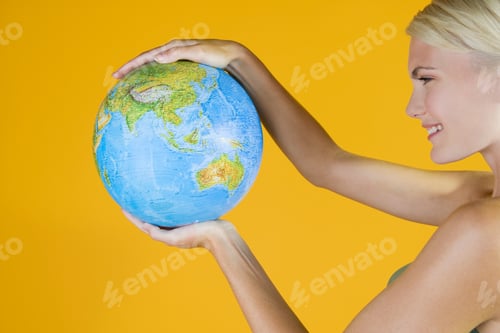 Preview: A Young Woman Holding A Globe