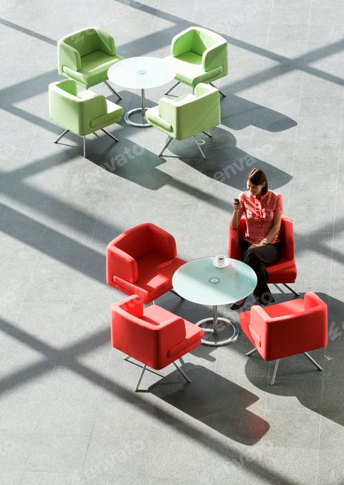 Preview: A Businesswoman Sitting At A Table Looking At A Mobile Phone