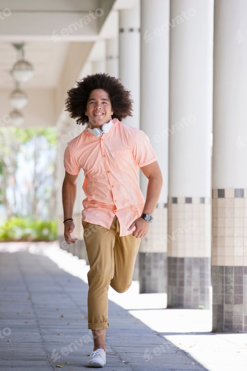 Preview: Portrait Of A Smiling Young Man Running Along The Corridor