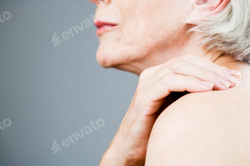 Preview: A Senior Woman With Her Hand On Her Shoulder