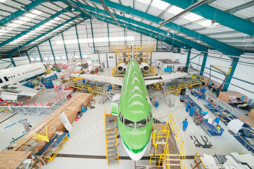 Preview: High Angle Wide Shot Of Engineers Working On A Passenger Jet At A Hangar.