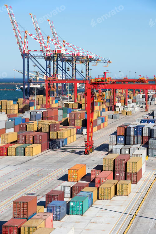 Preview: Vertical Wide Shot Of The Pathway At A Commercial Dock With Cranes And Cargo Containers.