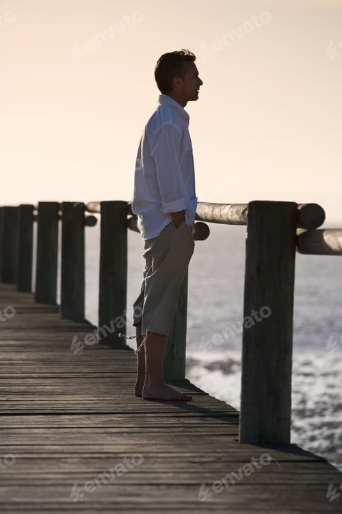 Preview: A Man Standing On A Boardwalk