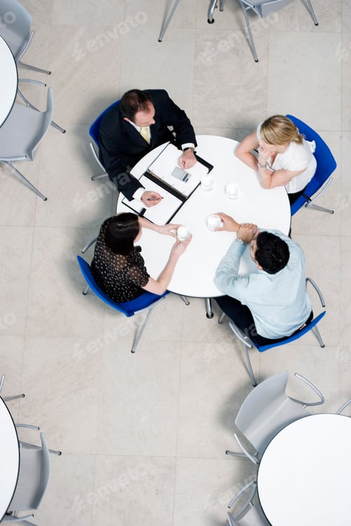 Preview: Overhead View Of Informal Business Meeting At Table Of Staff Canteen